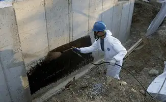 Professional waterproofing the exterior walls of the basement in New Orleans, LA