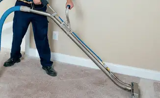 Professional operating a liquid removal machine on a carpeted floor in New Orleans, LA